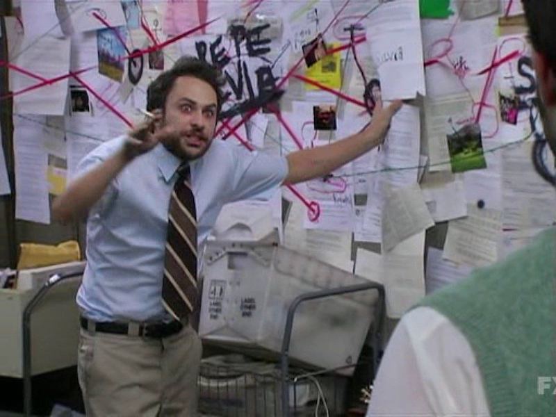 Charlie from It’s Always Sunny in Philadelphia pointing at a conspiracy board covered in notes and string
